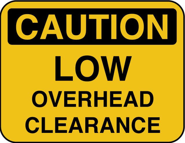 Height clearance caution sign for container delivery access.